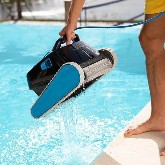 Maytronics Dolphin Nautilus CC Pro robotic pool cleaner on a residential pool floor with its sleek design and cleaning brushes.